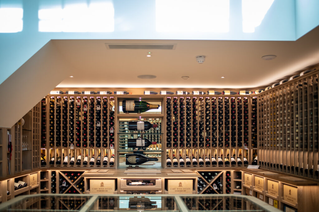 a wine wall with wine racking from floor to ceiling