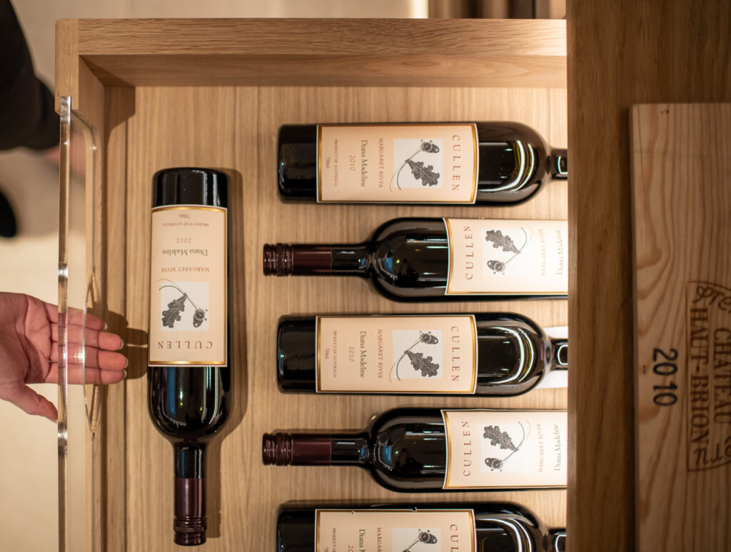 a view looking down onto multiple wine bottles, stored within a draw