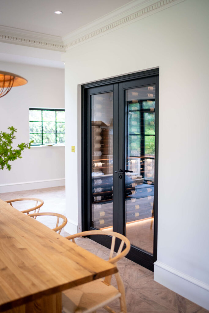 A wine cellar with dark wood double doors