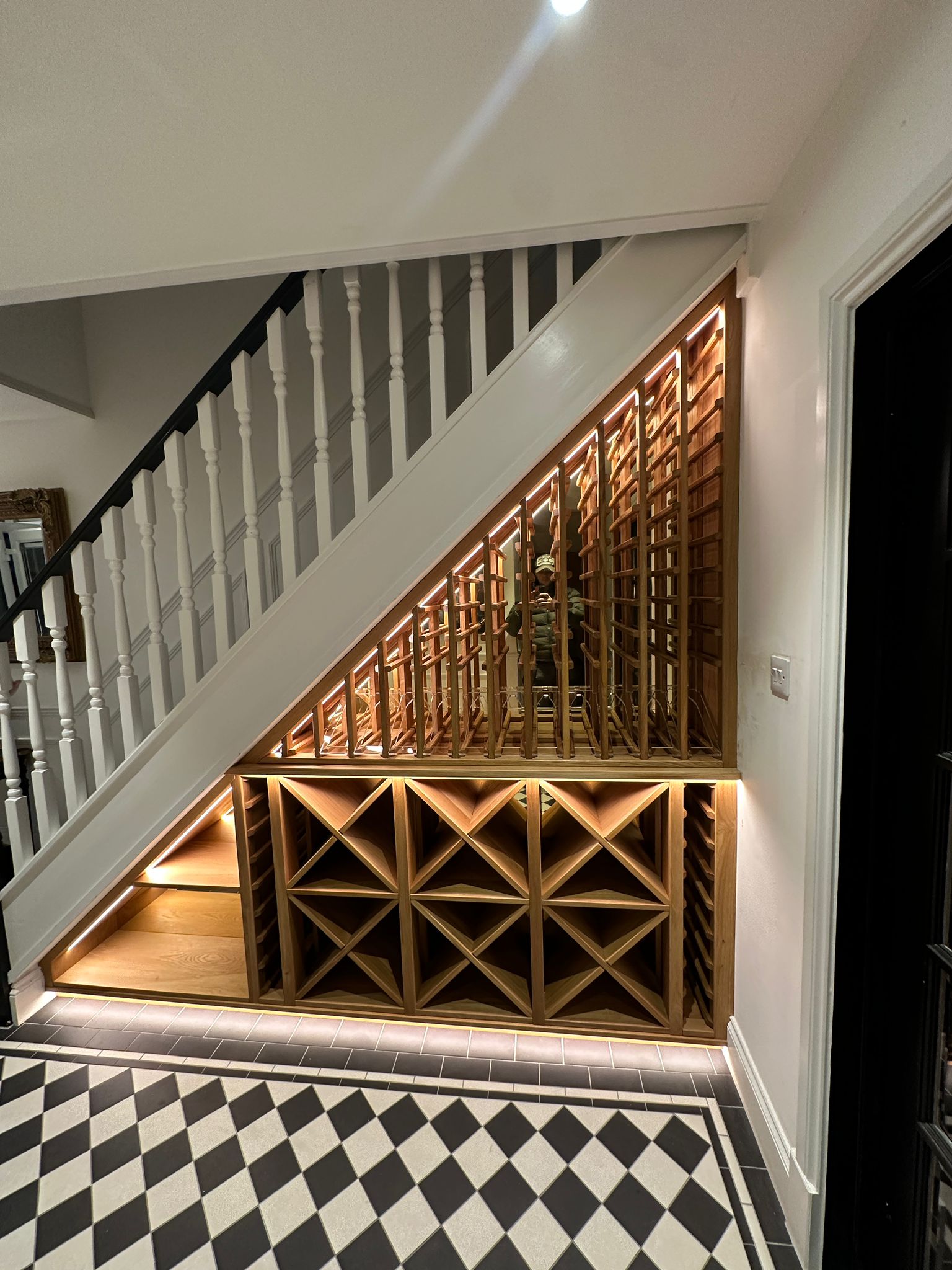 An under stairs wine rack, made by solid Oak for a private client. The wine rack features cubes below and standard under stairs wine racks above, providing a custom solution to perfectly fit the clients space.