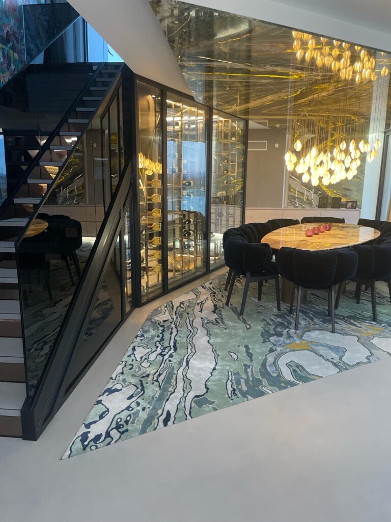 a black metal frame staircase with a modern wine cellar within