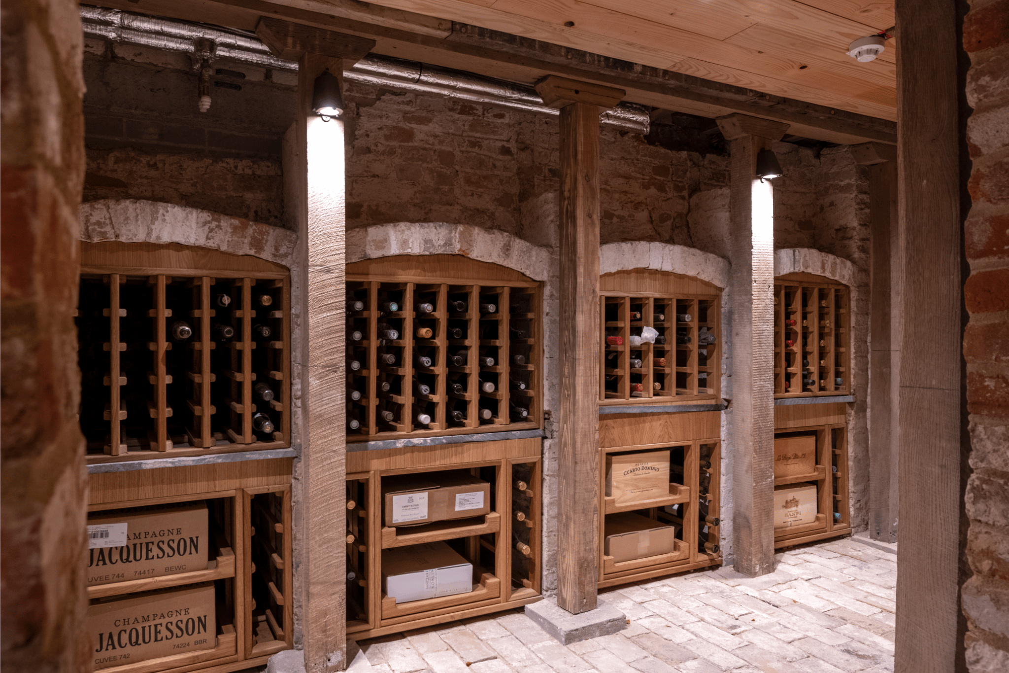 4 wine walls, built into the arches of an old brick wall