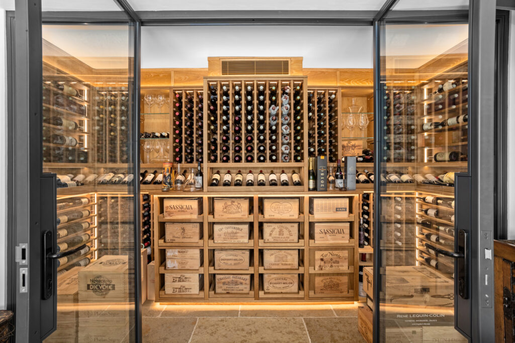 The front view of a wine cellar. The cellar doors are open, showing the wine racks within.