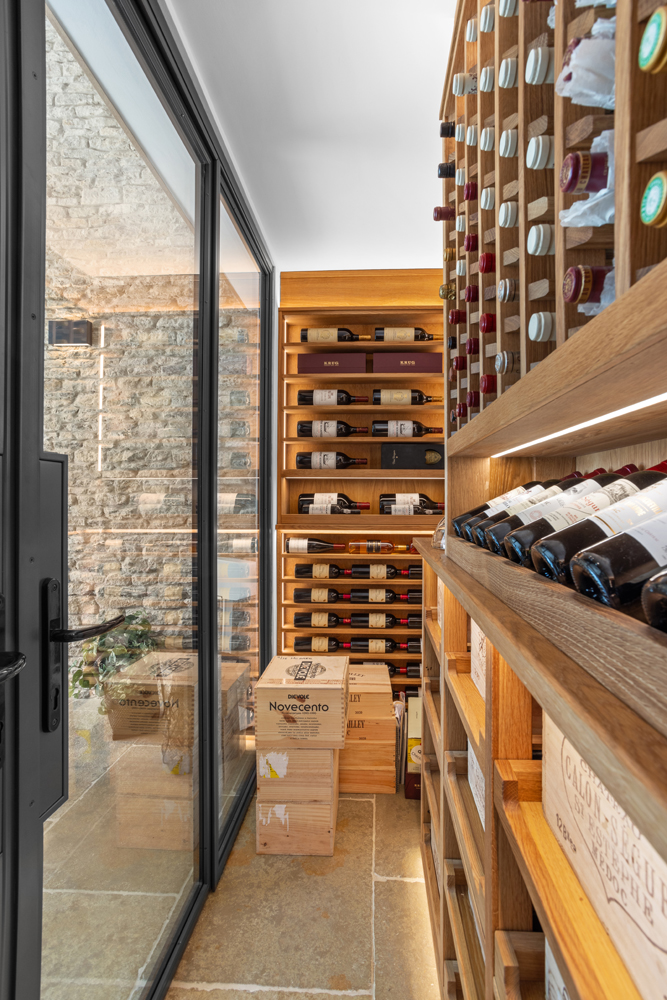 The side view of a wine cellar made from a light wood.