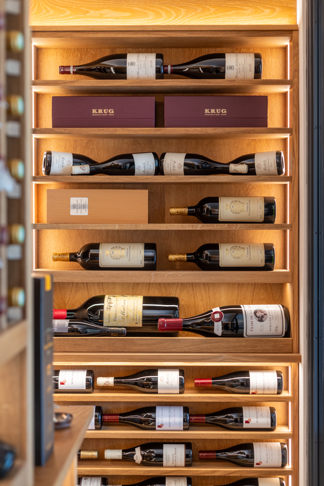 a row of scallop wine racks made from solid Oak with a light oak finish